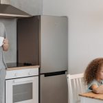 Man and children having breakfast in a cozy kitchen setting.